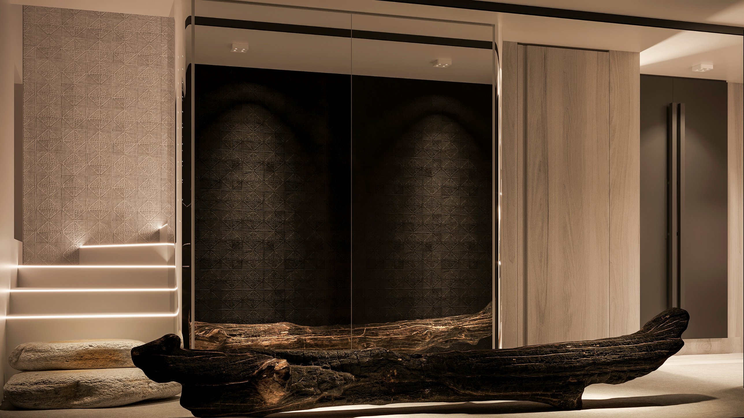 A charred driftwood bench before a mirrored wall reflecting dark patterned tiles, beside lit stairs