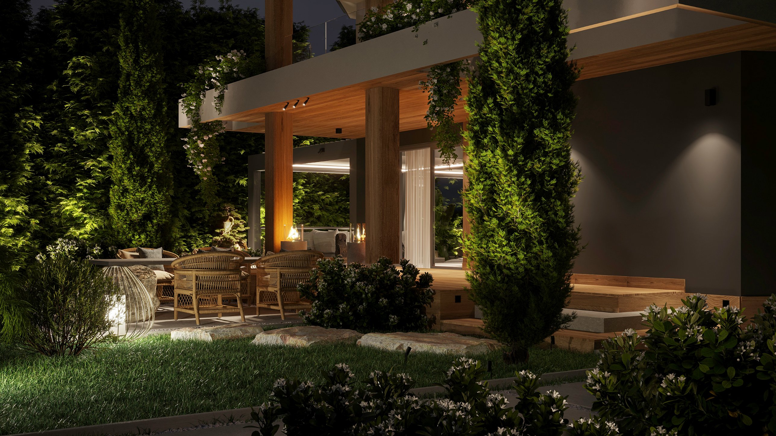 The terrace at night, lit among cypresses, with fire bowls glowing beneath the canopy