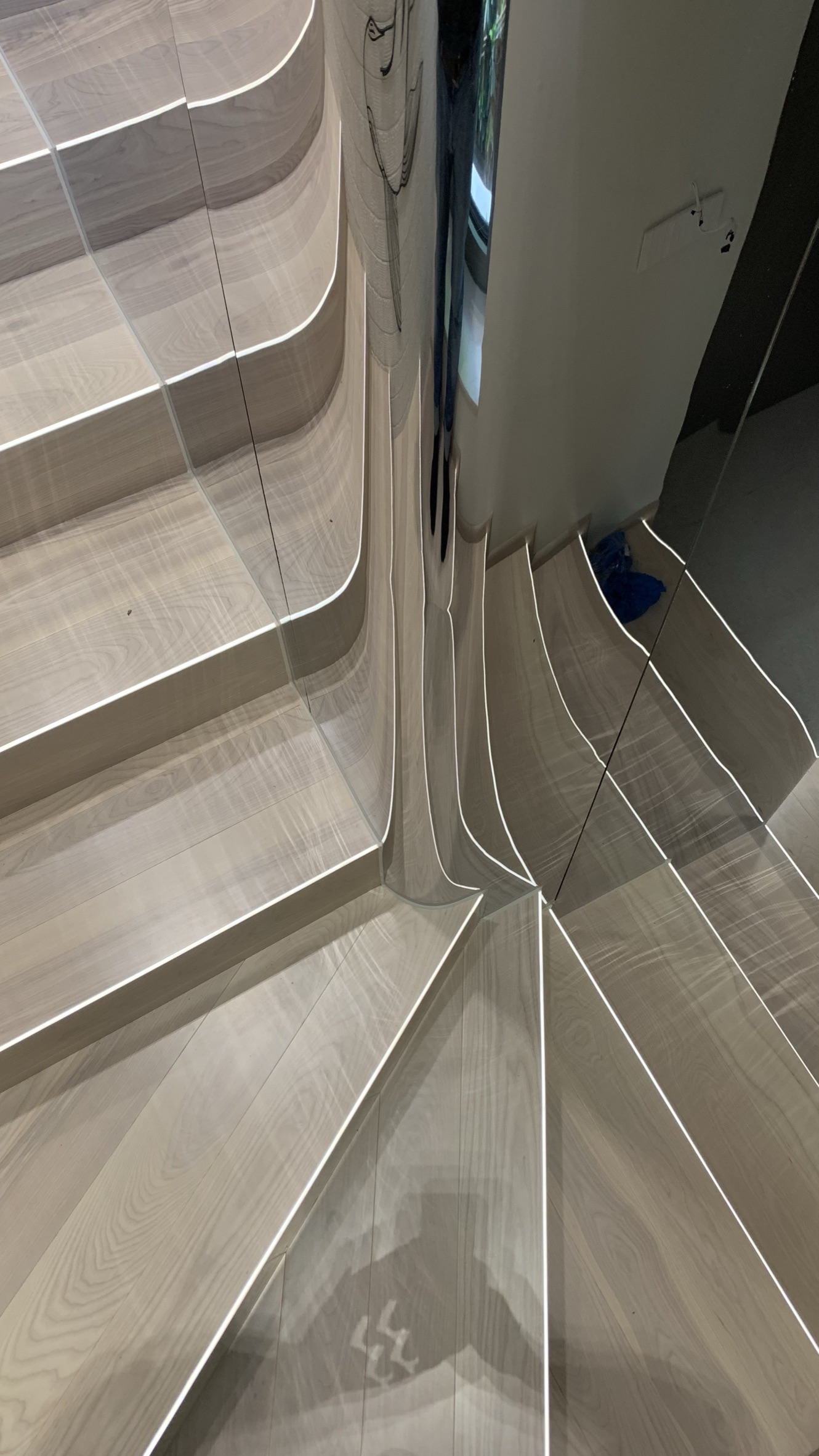 The staircase with lit edges and a mirrored wall
