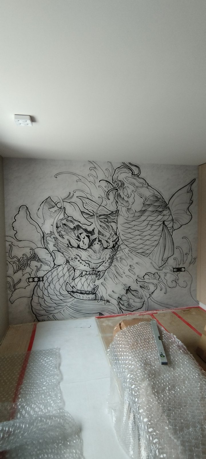 The koi mural on the bedroom wall before lighting