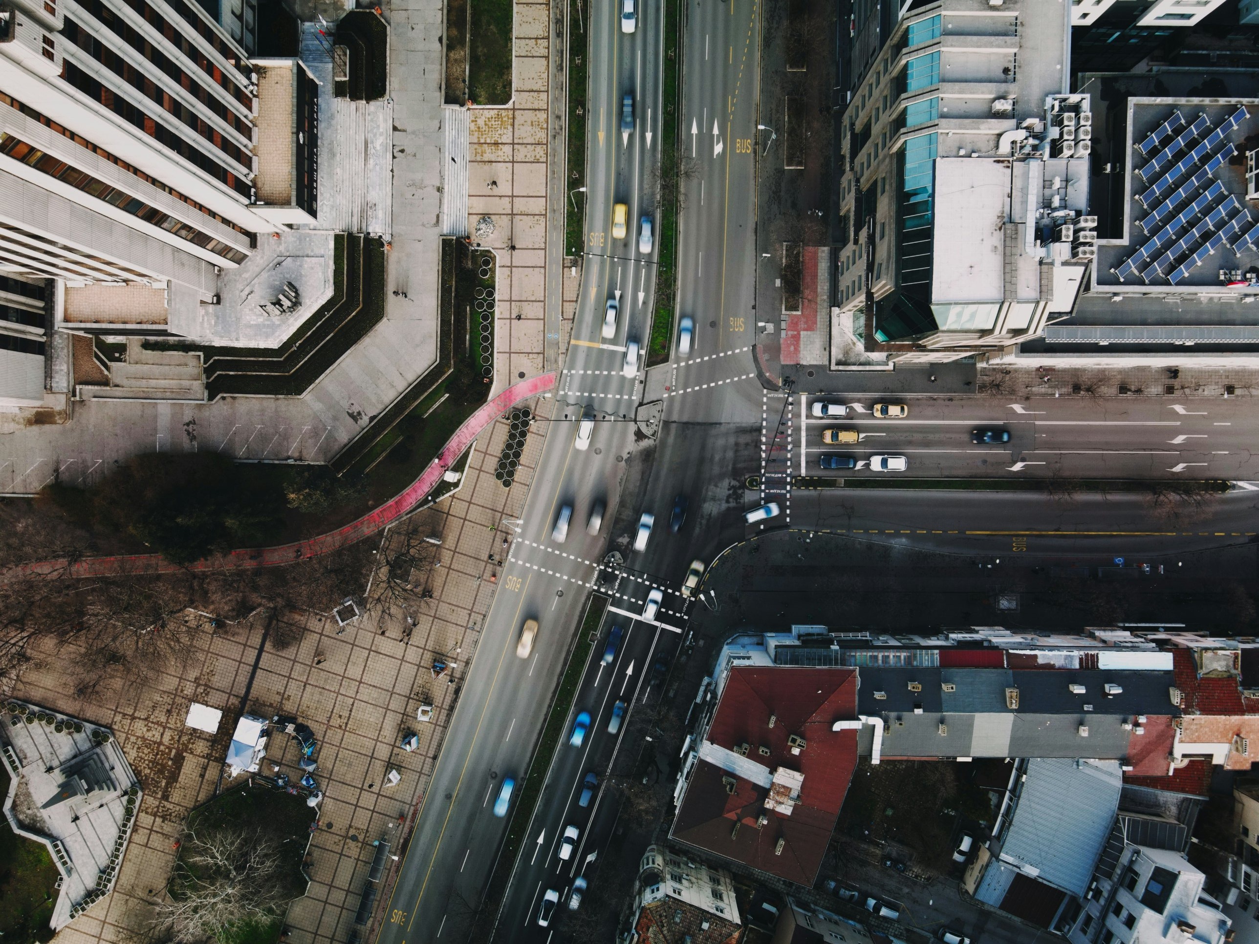 A crossroads in central Varna seen from directly above, with traffic in motion