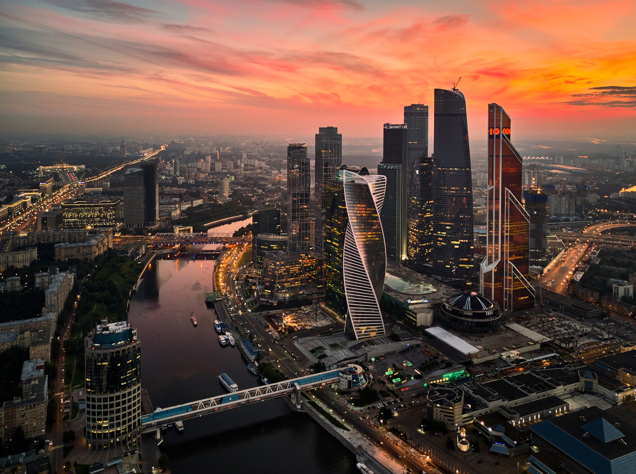 Moscow City at sunset, its towers rising above the river