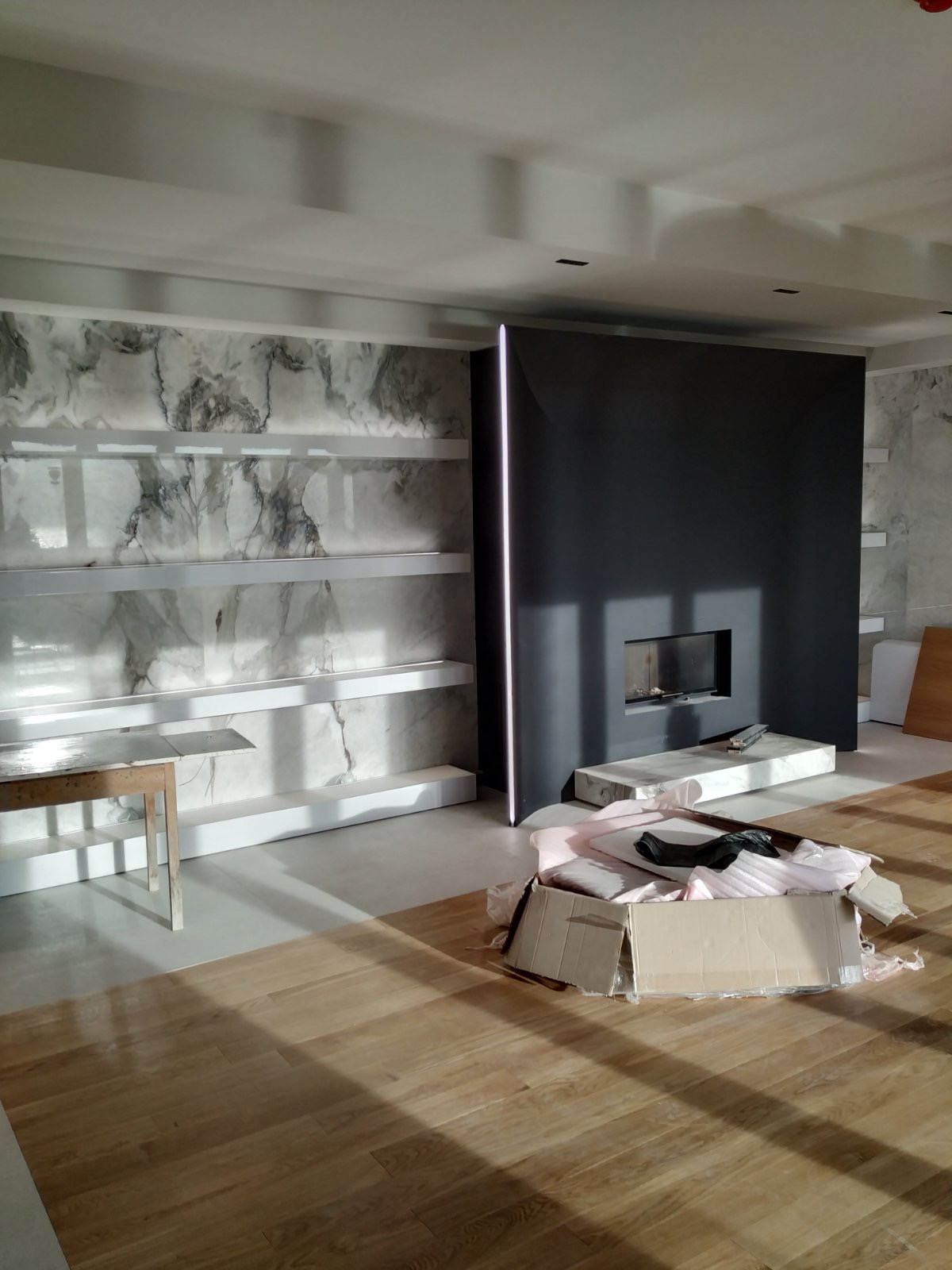 The fireplace and marble shelves under construction