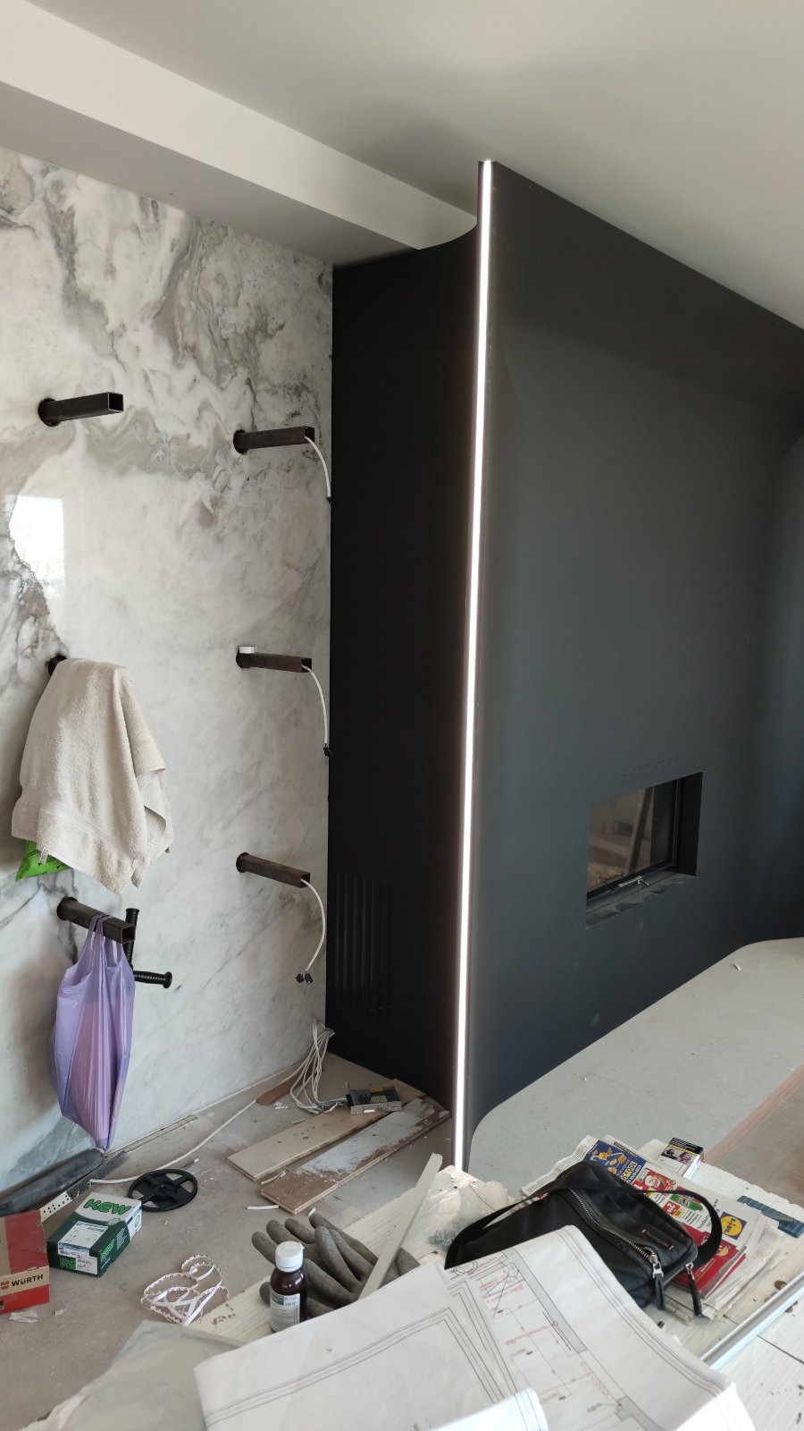 The steel fireplace with shelf brackets on site